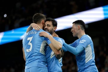 Bernardo Silva celebrates with Ruben Dias and Phil Foden of Manchester City 