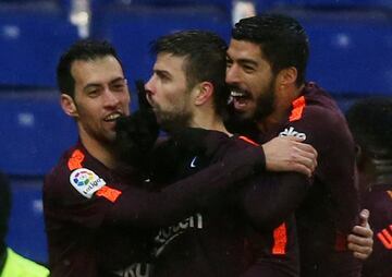 Gerard Piqué celebrates with Sergio Busquets and Luis Suárez after scoring. 1-1