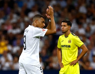 Real Madrid's Kylian Mbappé applauds fans after being substituted.