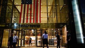 People and police officers stand outside Trump Tower after former US President Donald Trump said that FBI agents raided his Mar-a-Lago Palm Beach home.