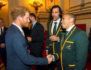 El príncipe Harry conversa con los jugadores sudafricanos Victor Matfield y Bryan Habana.