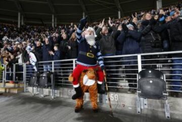 Un aficionado citizen anima a su equipo, vestido con un disfraz de Santa Claus subido sobre un reno, durante el partido entre el Hull City y su Manvhester City jugado durante el tradicional Boxing Day.