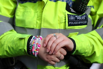 A police officer wears friendship bracelets, on the day of a Taylor Swift concert at Wembley Stadium in London.