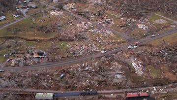 A derailed train is seen amid damage and debris after a devastating outbreak of tornadoes ripped through several U.S. states in Earlington, Kentucky.