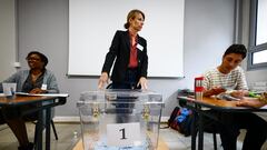 An election official stands in front of the ballot box at a polling station during the second round of the early French parliamentary elections, in Paris, France, July 7, 2024. REUTERS/Yara Nardi