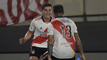 River Plate's forward Julian Alvarez (L) celebrates with teammate midfielder Enzo Fernandez after scoring his team's second goal against Patronato during the Argentine Professional Football League match at the Monumental stadium in Buenos Aires, Argentina, on February 16, 2022. (Photo by JUAN MABROMATA / AFP)