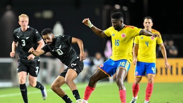 New Zealand's midfielder #10 Sarpreet Singh and Colombia's midfielder #16 Jefferson Lerma fight for the ball during the international friendly football match between Colombia and New Zealand at Chase Stadium in Fort Lauderdale, Florida, on November 15, 2025. (Photo by CHANDAN KHANNA / AFP)