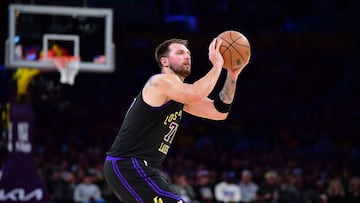 Mar 10, 2026; Los Angeles, California, USA; Los Angeles Lakers guard Luka Doncic (77) shoots against the Minnesota Timberwolves during the first half at Crypto.com Arena. Mandatory Credit: Gary A. Vasquez-Imagn Images