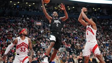 Dec 27, 2022; Toronto, Ontario, CAN; LA Clippers forward Kawhi Leonard (2) goes up to make a basket against Toronto Raptors guard Gary Trent Jr. (33) and forward Scottie Barnes (4) during the second half at Scotiabank Arena. Mandatory Credit: John E. Sokolowski-USA TODAY Sports