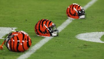 Cincinnati Bengals helmets sit on the grass before the start of the Bengals and Baltimore Ravens game.