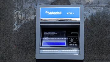 An automated teller machine operates at a branch of Sabadell bank in the Basque town of Guernica, Spain, October 26, 2022. REUTERS/Vincent West