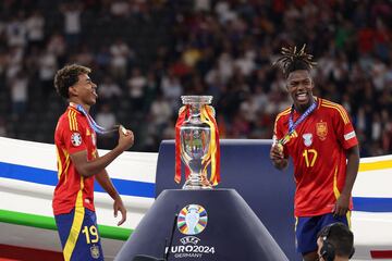 Spain's forward #19 Lamine Yamal (L) and Spain's midfielder #17 Nico Williams celebrate on the podium after winning the UEFA Euro 2024 final football match between Spain and England at the Olympiastadion in Berlin on July 14, 2024. (Photo by Adrian DENNIS / AFP)