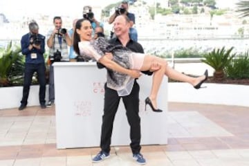 French director Karim Dridi carries French actress Nailia Harzoune in his arms as they pose on May 16, 2016 during a photocall for the film "Chouf" at the 69th Cannes Film Festival in Cannes, southern France.  / AFP PHOTO / Valery HACHE