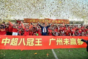 (FILES) This file photo taken on December 1, 2019 shows Guangzhou Evergrande's head coach Fabio Cannavaro (C), players and staff members celebrating after defeating Shanghai Shenhua to win the Chinese Super League (CSL) football championship in Guangzhou 