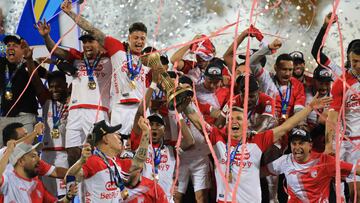 Independiente Santa Fe players celebrate with the trophy after winning the Colombian football championship final match between Independiente Medellin and Independiente Santa Fe at the Atanasio Girardot Stadium in Medellin, Colombia, on June 29, 2025. (Photo by JAIME SALDARRIAGA / AFP)