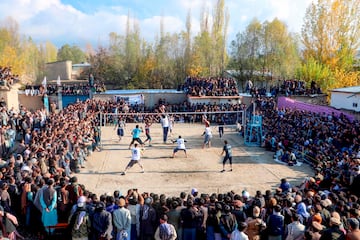 Un grupo de jóvenes afganos compite durante un partido de voleibol disputado en un vetusto y destartalado campo de tierra. El encuentro, que tuvo lugar en el distrito de Argo, en la provincia de Badakhshan, generó gran expectación entre el público local, que abarrotó el pequeño recinto con aficionados subidos en vallas y en tejados.