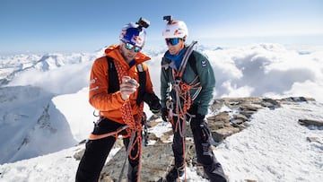 Nicolas Hojac and Philipp Brugger checking the time on the Jungfrau summit after climbing the Eiger, Moench and Jungfrau north faces in a day on April 05, 2025.