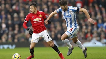 Manchester United&#039;s Alexis Sanchez, left, and Huddersfield Town&#039;s Tommy Smith, during their English Premier League soccer match at Old Trafford in Manchester, England, Saturday Feb. 3, 2018. (Martin Rickett/PA via AP)