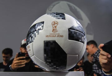 Attendees take pictures of the official match ball for the 2018 World Cup, named "Telstar 18", during its unveiling ceremony in Moscow on November 9, 2017.