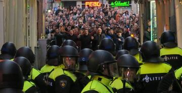 Why always us? England fans and police - Amsterdam on Friday evening.