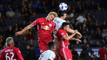 Zlatan Ibrahimovic of the LA Galaxy vies for the header with Aaron Long (L) and Florian Valot (R) of the New York Red Bulls in their MLS match in Carson, California on April 28, 2018. / AFP PHOTO / FREDERIC J. BROWN