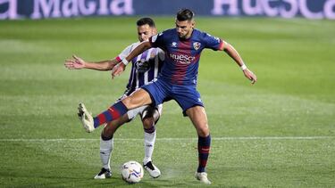 HUESCA, SPAIN - OCTOBER 18: Rafa Mir of SD Huesca is challenged by Bruno Gonzalez of Real Valladolid during the La Liga Santader match between SD Huesca and Real Valladolid CF at Estadio El Alcoraz on October 18, 2020 in Huesca, Spain. Football Stadiums a