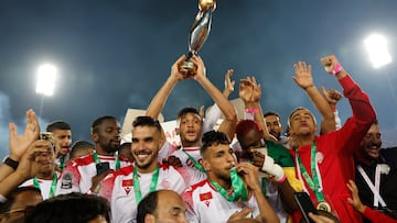 Soccer Football - CAF Champions League - Final - Al-Ahly v Wydad Casablanca - Mohammed V Stadium, Casablanca, Morocco - May 30, 2022 Wydad Casablanca's Guy Mbenza and teammates celebrate with the trophy after winning the CAF Champions League REUTERS/Juan Medina