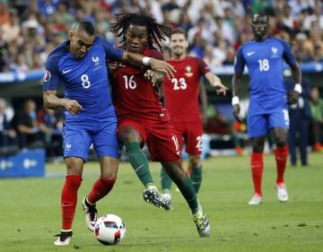 Renato Sanches of Portugal and Dimitri Payet of France battle for the ball.