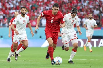 AL RAYYAN, QATAR - NOVEMBER 22:  Andreas Christensen of Denmark brings the ball away from Ellyes Skhiri (R) and Anis Slimane of Tunisia during the FIFA World Cup Qatar 2022 Group D match between Denmark and Tunisia at Education City Stadium on November 22, 2022 in Al Rayyan, Qatar. (Photo by Jean Catuffe/Getty Images)