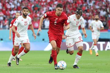 AL RAYYAN, QATAR - NOVEMBER 22:  Andreas Christensen of Denmark brings the ball away from Ellyes Skhiri (R) and Anis Slimane of Tunisia during the FIFA World Cup Qatar 2022 Group D match between Denmark and Tunisia at Education City Stadium on November 22, 2022 in Al Rayyan, Qatar. (Photo by Jean Catuffe/Getty Images)