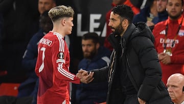 Manchester United's Portuguese head coach Ruben Amorim (R) shakes hands with Manchester United's Argentinian midfielder #17 Alejandro Garnacho (L) as he leaves the game, substituted during the UEFA Europa league quarter-final final, second leg football match between Manchester United and Lyon at Old Trafford stadium in Manchester, north west England, on April 17, 2025. (Photo by Oli SCARFF / AFP)