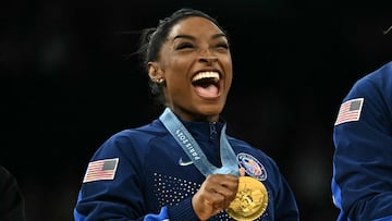 US' Simone Biles poses with the gold medal during the podium ceremony for the artistic gymnastics women's team final during the Paris 2024 Olympic Games at the Bercy Arena in Paris, on July 30, 2024. (Photo by Lionel BONAVENTURE / AFP)
