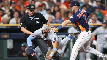 Houston Astros third baseman Alex Bregman (R) tags out Minnesota Twins designated hitter Royce Lewis (C)