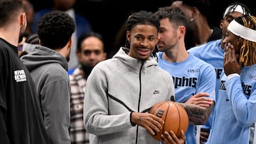 Nov 22, 2025; Dallas, Texas, USA; Memphis Grizzlies guard Ja Morant (12) looks on from the team bench during the second half against the Dallas Mavericks at the American Airlines Center. Mandatory Credit: Jerome Miron-Imagn Images