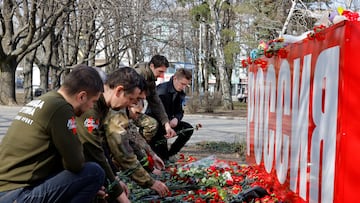 People lay flowers at the stele "Russia" in memory of the victims of a shooting attack at the Crocus City Hall concert venue outside Moscow, in Donetsk, Russian-controlled Ukraine, March 23, 2024. REUTERS/Alexander Ermochenko