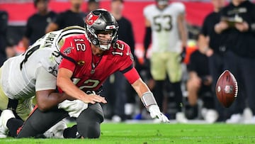 TAMPA, FLORIDA - DECEMBER 19: Tom Brady #12 of the Tampa Bay Buccaneers fumbles the ball as he is hit by Cameron Jordan #94 of the New Orleans Saints during the 4th quarter of the game at Raymond James Stadium on December 19, 2021 in Tampa, Florida. Jul