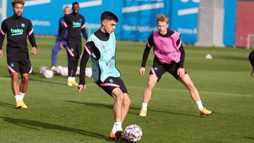 Pedri, que hoy podr&iacute;a descansar, toca el bal&oacute;n en el entrenamiento de ayer con Konrad y De Jong.