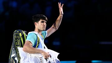 Spain's Carlos Alcaraz waves as he leaves the court after being defeated by Norway's Casper Ruud at the ATP Finals tennis tournament in Turin on November 11, 2024. (Photo by Marco BERTORELLO / AFP)