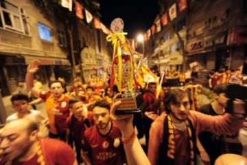 Fanáticos del equipo Galatasaray celebran, la Superliga de Campeones de Turquía, en Estambul (Turquía). El Galatasaray logró su vigésimo título de campeón de la Liga turca, tras el empate (2-2) cosechado hoy por el Fenerbahce, segundo clasificado, en su visita al campo del Istanbul Basaksehir. 