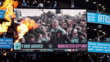 Manchester City supporters cheer as the Manchester City's Norwegian striker #09 Erling Haaland arrives with teammates outside of the Etihad Stadium, in Manchester, north-west England, ahead of the UEFA Champions League quarter-final second-leg football match between Manchester City and Real Madrid, on April 17, 2024. (Photo by Darren Staples / AFP)