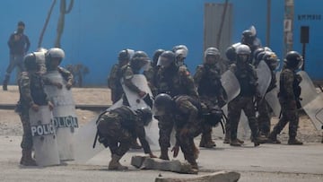 Riot police clear a road during clashes with demonstrators which erupted in the framework of a partial strike of cargo and passenger carriers, in Ate, a district east of Lima, on April 4, 2022. - A partial strike of cargo and passenger carriers caused road blockades and suspension of classes in Peru, in the first strike against the government of leftist President Pedro Castillo. (Photo by Gian MASKO / AFP) (Photo by GIAN MASKO/AFP via Getty Images)