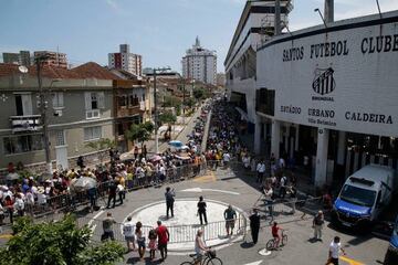 Fans of late Brazilian football legend Pele gather outside the Urbano Caldera stadium to attend his wake in Santos, Sao Paulo, Brazil on January 2, 2023. - Brazilians bid a final farewell this week to football giant Pele, starting Monday with a 24-hour public wake at the stadium of his long-time team, Santos. (Photo by Miguel SCHINCARIOL / AFP) (Photo by MIGUEL SCHINCARIOL/AFP via Getty Images)