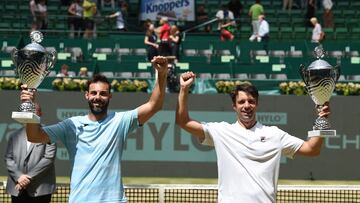 Marcel Granollers (L) from Spain and Horacio Zeballos from Argentinia celebrate their victory as Double at the ATP 500 Halle Open tennis tournament in Halle, western Germany, on June 19, 2022. (Photo by CARMEN JASPERSEN / AFP)