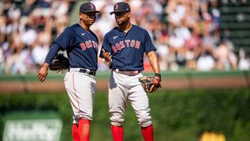 CHICAGO,IL - JULY 3: Rafael Devers #11 reacts with Xander Bogaerts #2 of the Boston Red Sox during the seventh inning of a game against the Chicago Cubs on July 3, 2022 at Wrigley Field in Chicago, Illinois. (Photo by Billie Weiss/Boston Red Sox/Getty Images)