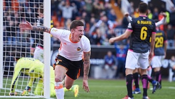 Santi Mina (L) of Valencia celebrates after scoring the second goal during the La Liga match between Valencia CF and RCD Espanyol at Mestalla Stadium 