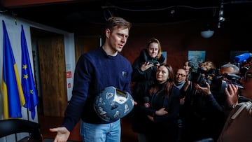 Vladyslav Heraskevych, a Ukrainian skeleton racer, holds his helmet with images depicting athletes killed since the start of Russia's invasion of Ukraine, and his father and coach, Mykhailo Heraskevych, during a press conference after he was disqualified from the Milano Cortina 2026 Winter Olympic Games for wearing it, in Kyiv, Ukraine, February 19, 2026. REUTERS/Alina Smutko