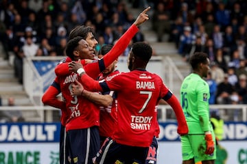 Lille's Canadian forward Jonathan David (C) celebrates scoring his team's first goal during the match between AJ Auxerre and Lille LOSC at Stade de l'Abbe-Deschamps in Auxerre.