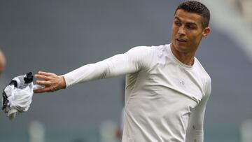 TURIN, ITALY - APRIL 11: Cristiano Ronaldo of Juventus removes his jersey to give to a ballboy following the final whistle of the Serie A match between Juventus and Genoa CFC at Allianz Stadium on April 11, 2021 in Turin, Italy. (Photo by Jonathan Moscrop