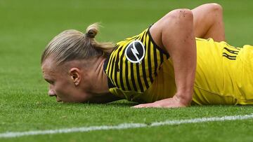 Dortmund's Norwegian striker Erling Haaland lies on the pitch during the German first division Bundesliga football match FC Bayern Munich v BVB Borussia Dortmund in Munich, southern Germany on April 23, 2022. (Photo by Christof STACHE / AFP) / DFL RE