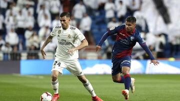 MADRID, SPAIN - MARCH 31:  Dani Ceballos of Real Madrid is closed down by Camilo Hernandez of Huesca during the La Liga match between Real Madrid CF and SD Huesca at Estadio Santiago Bernabeu on March 31, 2019 in Madrid, Spain. (Photo by Gonzalo Arroyo Mo